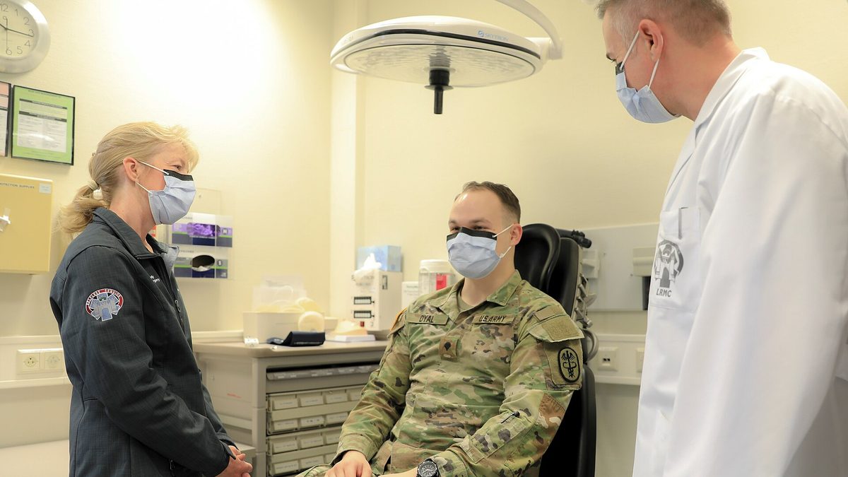 A nurse preparing a patient for a medical exam at a clinic