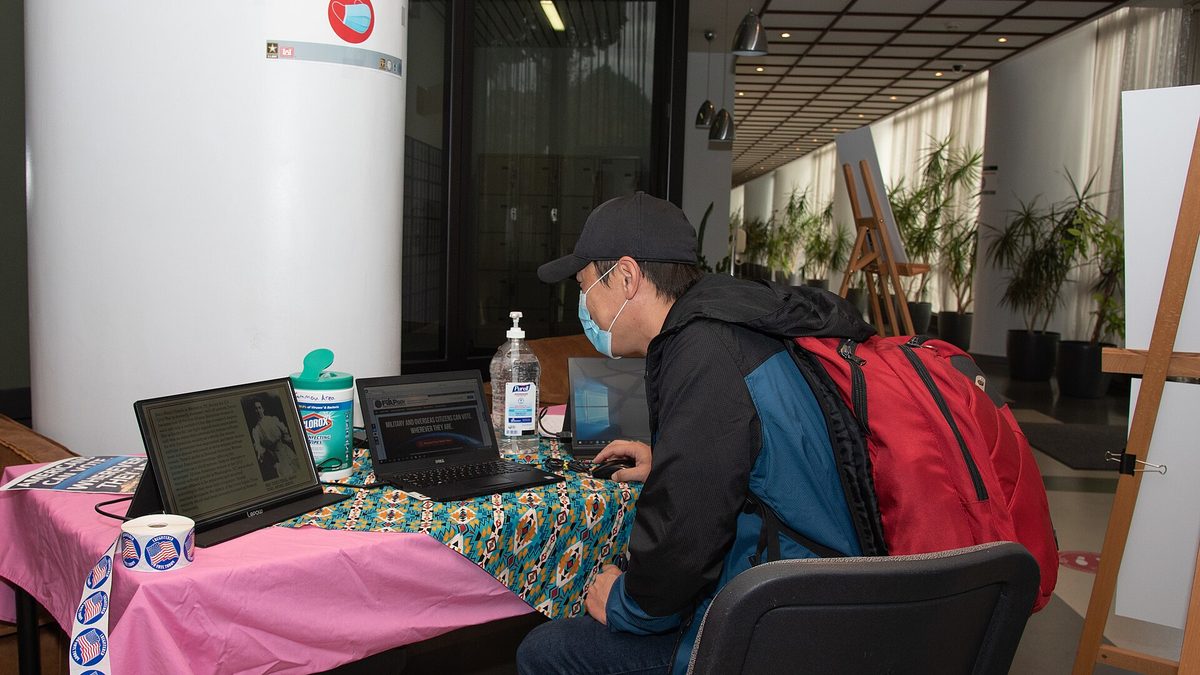 A voter checking absentee ballot information on the Federal Voting Assistance Program website